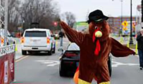 Person dressed as a turkey at a race