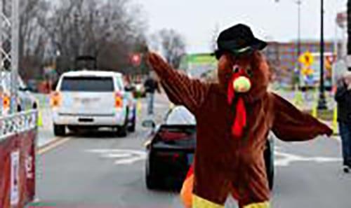 Person dressed as a turkey at a race