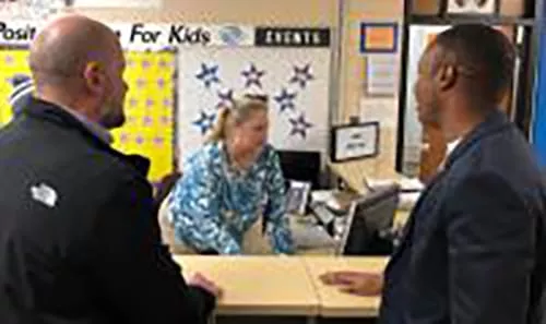 Two people at the front desk of Flint Boys and Girls Club
