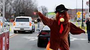 Person dressed as a turkey at a race